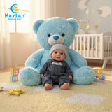 10 inch baby boy sitting with a bear on the floor